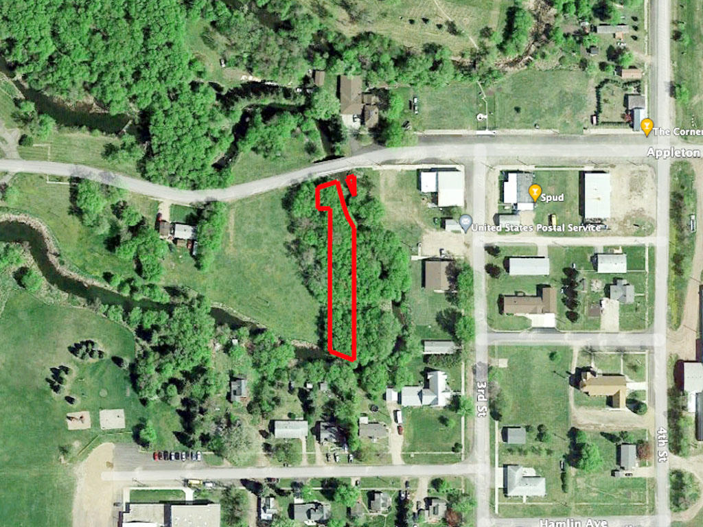 Nice sized lot alongside a creek in a beautiful, small town - Image 1