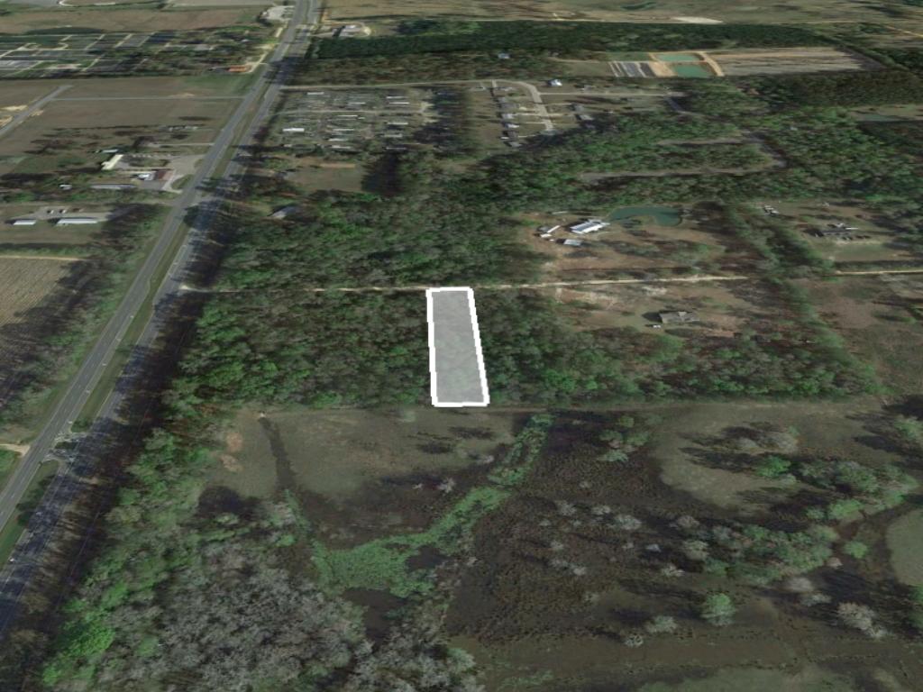 Almost an acre of narrow property backing a large open field - Image 2